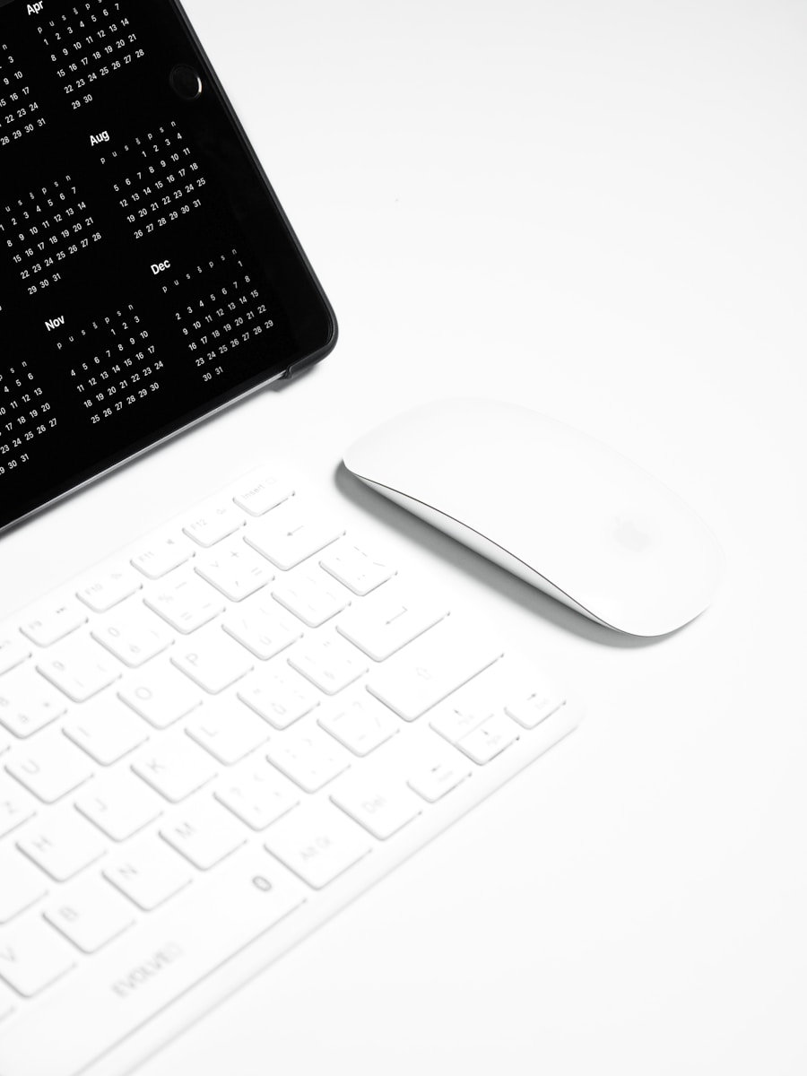 A computer keyboard and a mouse on a desk